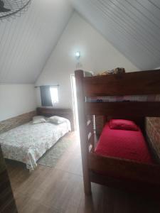 a bedroom with two bunk beds in a attic at Chalé Arizona in São Roque +12 photos