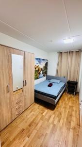 a bedroom with a bed and a painting on the wall at Ulven Paradise in Oslo