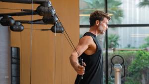 a man holding a bow and arrow in a gym at Grand Hyatt Cancun Beach Resort in Cancún