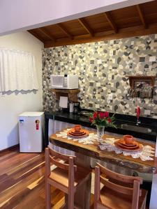 a kitchen with a table with plates on it at Chalés Vale das Pedras in Venda Nova do Imigrante