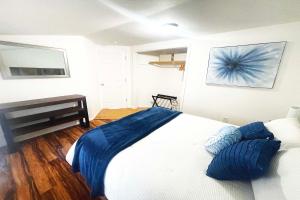 a bedroom with a bed with blue pillows on it at Westport Whitehouse in Westport