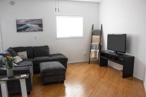 a living room with a couch and a tv at Westport Whitehouse in Westport