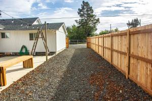 a backyard with a fence and a playground at Westport Whitehouse in Westport