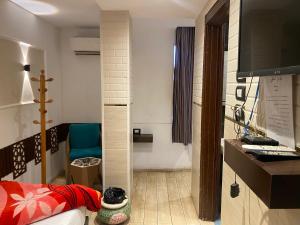 a room with a bedroom with a bed and a tv at Shaheen hotel in Suez