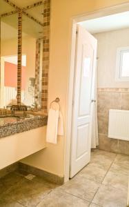 a bathroom with a sink and a mirror at Hotel Lunajuim in El Chalten +51 photos