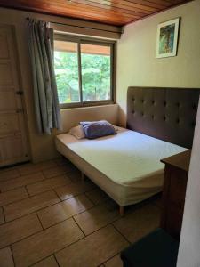 a bedroom with a large bed with a window at Wendy Location in Papeete +15 photos
