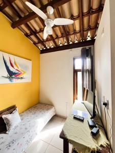 a bedroom with a bed and a desk with a computer on it at Flat Barra in Barra Grande