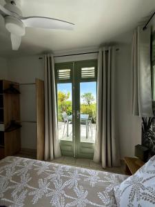 a bedroom with a bed and a sliding glass door at Gîte Ti Volkan in Saint-Claude