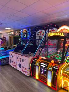 a room with two arcade games in a room at Paws a while in Mainsriddle