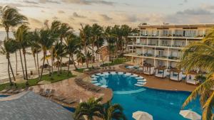 an aerial view of a resort with a pool and palm trees at Iberostar Selection Riviera Cancun - All Inclusive in Puerto Morelos