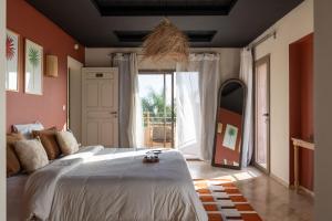 a bedroom with a large bed and a large window at Smala Beldi Guest House in Essaouira +70 photos