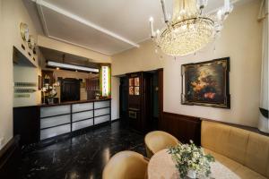 a dining room with a chandelier and a table at Hotel Most Slávy in Martinske Hole