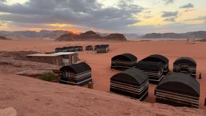 a group of domes in the middle of the desert at Wadi Rum Trip Bedouin Camp in Wadi Rum