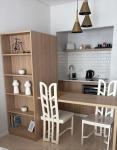 a kitchen with a wooden table and chairs at Studios Montevideo in Buenos Aires