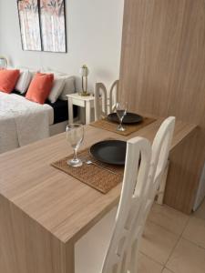 a dining table with two glasses and a plate on it at Studios Montevideo in Buenos Aires +16 photos