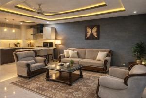 a living room with a couch and chairs and a table at The Nest Apartment in Rawalpindi