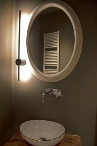 a bathroom with a sink and a mirror at Appartamento PALE 2 posti letto in Pale