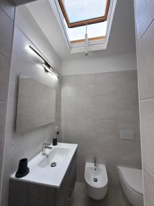 a bathroom with a sink and a mirror and a toilet at Soul house in Corsico +13 photos