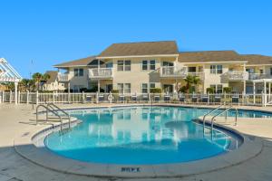 a swimming pool in front of a villa at Sandpiper Cove by Panhandle Getaways in Destin +18 photos