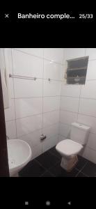 a bathroom with a toilet and a sink at Recanto do Garças in Aragarças +27 photos