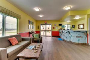 a living room with a couch and a table at The Island Hotel Near Beach Port Aransas in Port Aransas