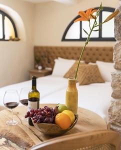a table with a bowl of fruit and wine bottles at המילטון 2 - Hamilton 2 in Safed +8 photos