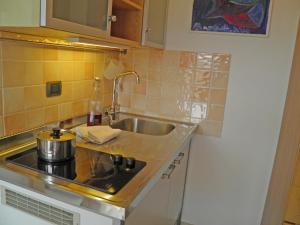 a kitchen with a sink and a stove top oven at Asti in Gravedona +19 photos