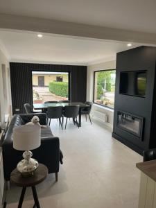 a living room with a couch and a table and a tv at Bragan Mountain View in Monaghan