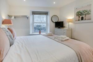 a bedroom with a large white bed with towels on it at 2 Bed in Penzance oc-u34133 in Penzance