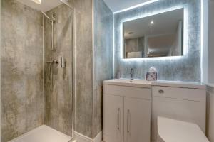 a bathroom with a shower and a sink and a mirror at 1 Bed in Penzance oc-u34132 in Penzance