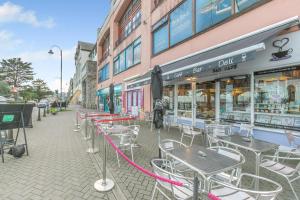 a row of tables and chairs in front of a building at 1 Bed in Penzance oc-u34132 in Penzance