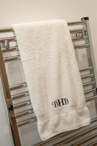 a white towel hanging on the door of a refrigerator at Bridge House Barn in Kibworth Harcourt +63 photos