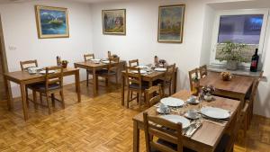 a dining room with wooden tables and chairs at Domačija Log v Bohinju in Bohinjska Bistrica