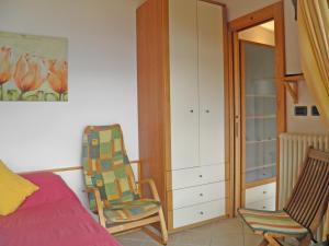 a bedroom with a bed and a chair and a closet at Asti in Gravedona