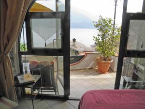 a room with a window with a view of the water at Asti in Gravedona