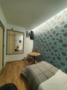 a bedroom with a bed and a mirror on the wall at Wander Luxe hostel in Tirana
