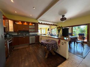 a kitchen with wooden cabinets and a table in it at Casa Valdres in Santa Cruz La Laguna