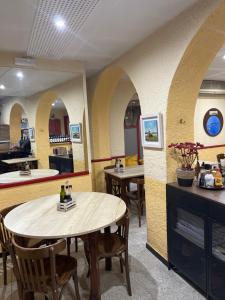 a restaurant with a table and chairs in a room at Hostal Ripollès in Ripoll