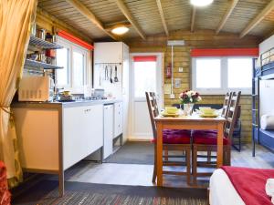 a kitchen with a table and chairs in a room at Robin's Lodge in Westward