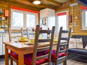 a dining room with a wooden table and chairs at Robin's Lodge in Westward