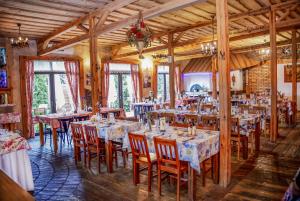a restaurant with tables and chairs in a room at Karczma Kujawska in Inowrocław