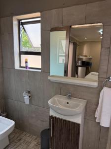 a bathroom with a sink and a mirror at Petron home in Kempton Park +48 photos