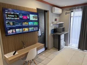 a room with a television on a wall with a chair at Petron home in Kempton Park