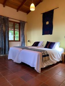 a bedroom with two beds in a room at Casa Valdres in Santa Cruz La Laguna +25 photos