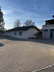 a large white building with a brick driveway at Loft05 in Wankham +7 photos