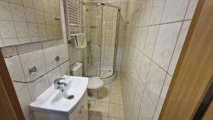 a bathroom with a sink and a toilet at Villa Atol in Niechorze +6 photos