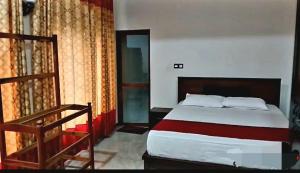 a bedroom with a large bed and a staircase at Kanmani Guest House in Kondavil
