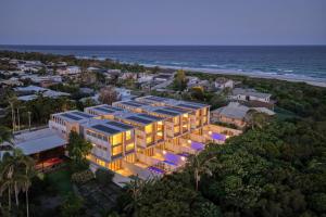 an aerial view of a building on the beach at Solis Villa in Pottsville