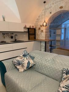 a bed with two pillows on it in a kitchen at Virgin Mare in Giovinazzo