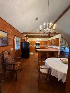 a kitchen with a table and chairs in a room at The Piney Woods Cabin in Nacogdoches